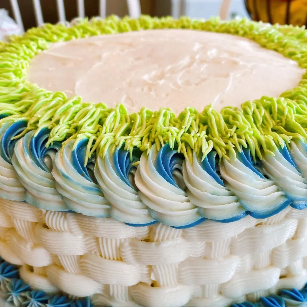 Outer edges of frosting on the basket cake.