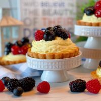 Fruit Tartlets on a cupcake stand with lots of fresh fruit.