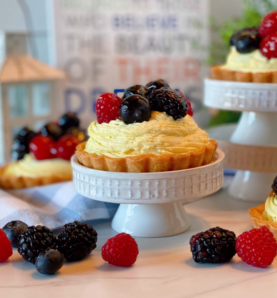 Fruit Tartlets on a cupcake stand with lots of fresh fruit.