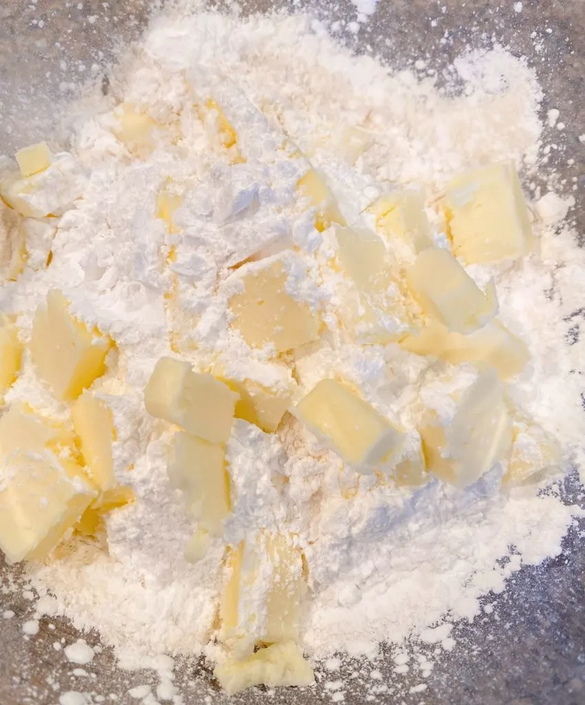Adding cold butter to flour mixture.