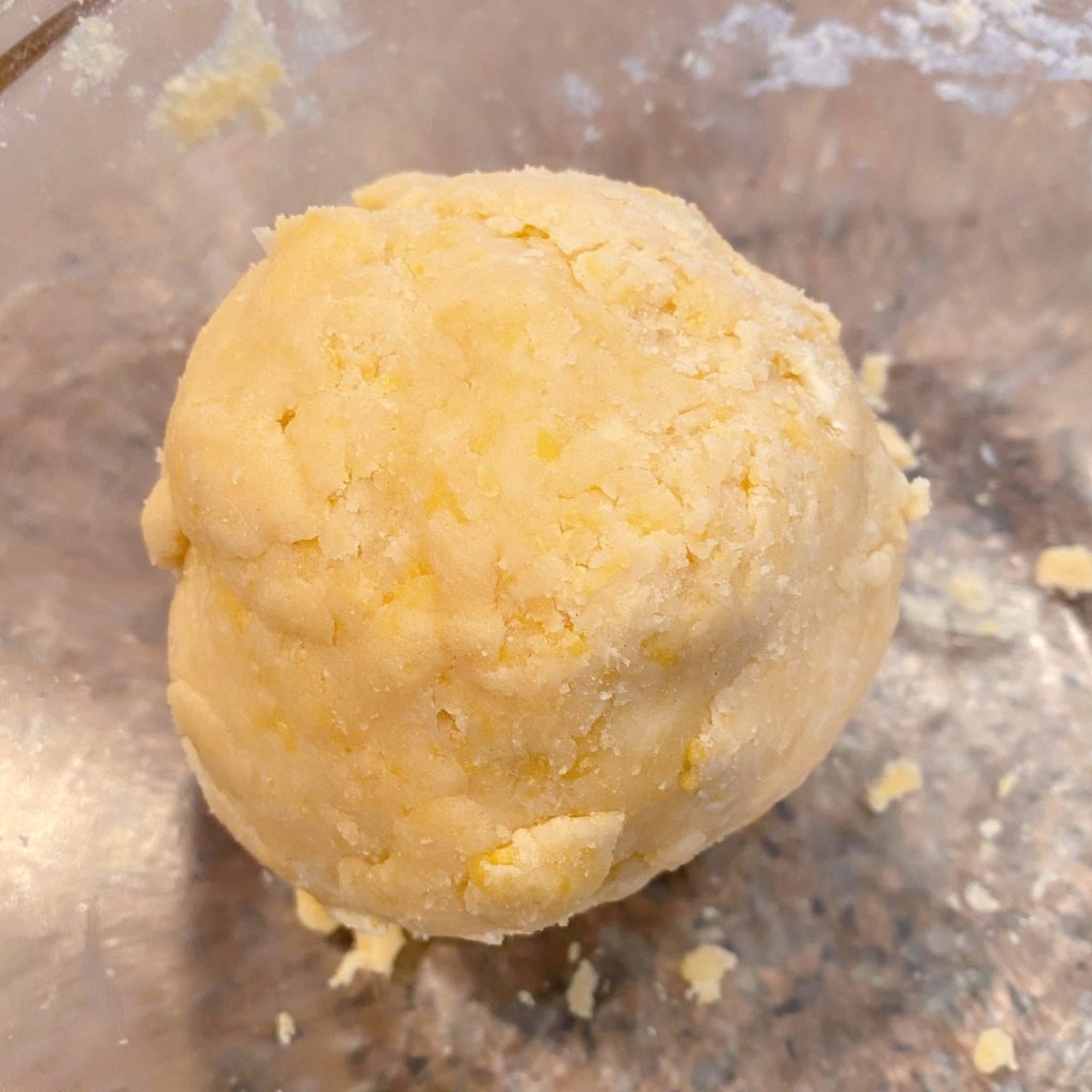 short bread crust for tarts gathered into a ball and sitting in a glass bowl.