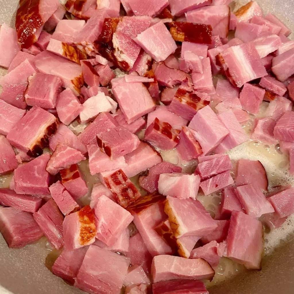 Large skillet over medium-high heat browing chopped ham.