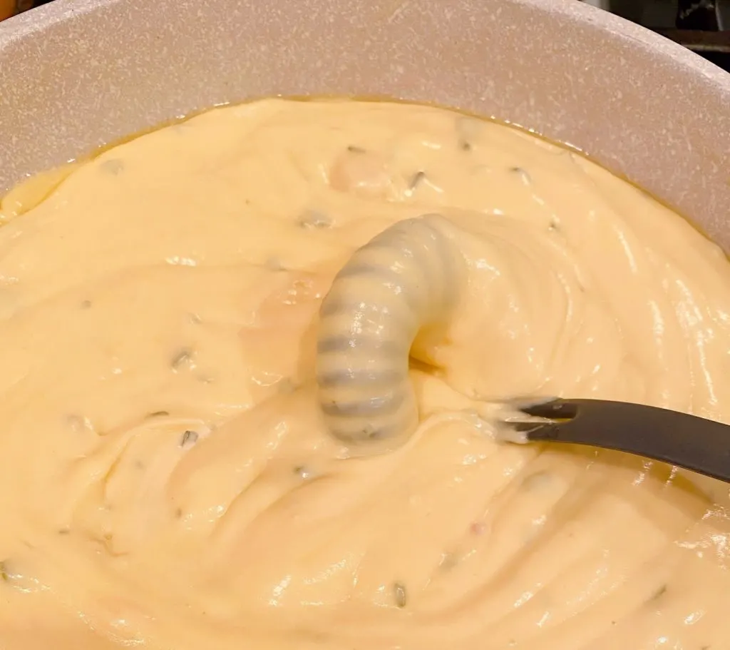 Cheese sauce in large skillet over medium heat.