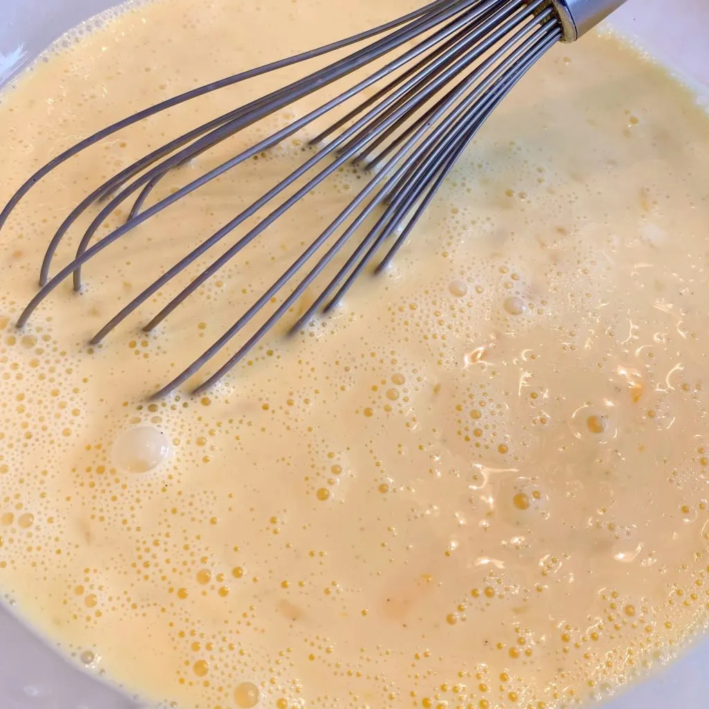 Whisking batter ingredients until combined with wire whisk.