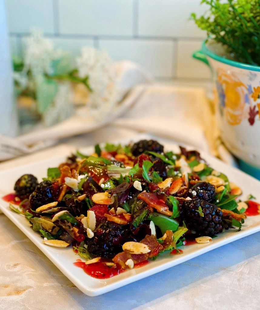 Berry Feta Salad with dressing on a single salad plate.