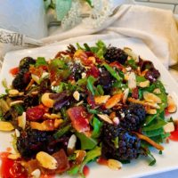 Blackberry Feta Spring Salad with Raspberry Vinaigrette Dressing on a salad plate.