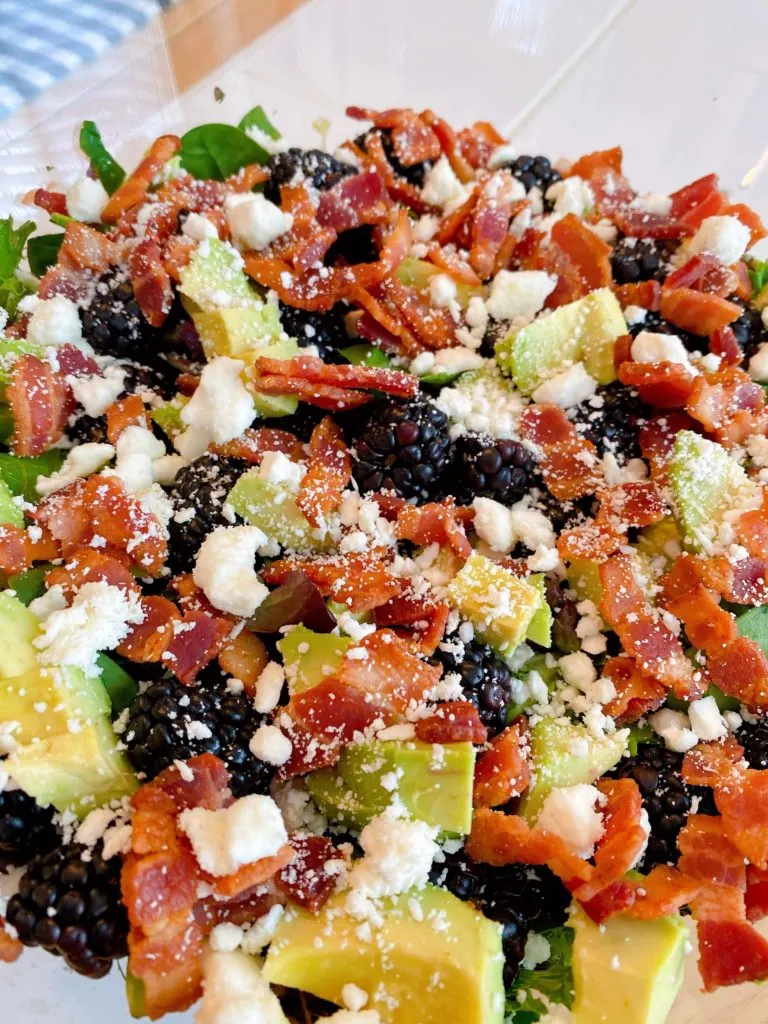 Feta Cheese sprinkled over top of berries, avocados, and bacon.