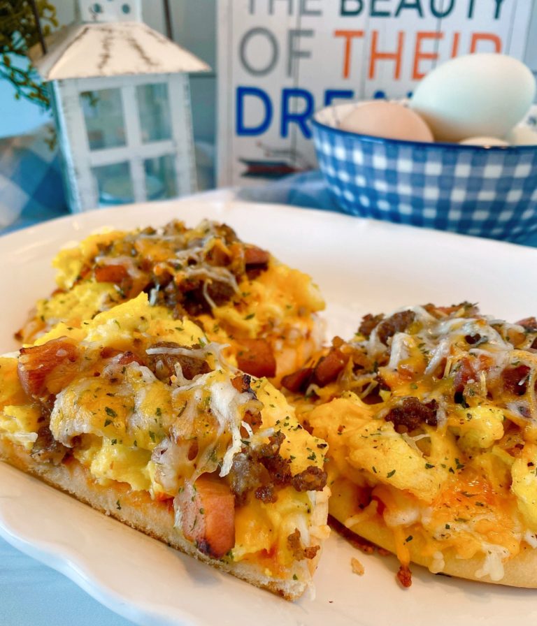 Individual sized breakfast pizzas on a white serving platter.