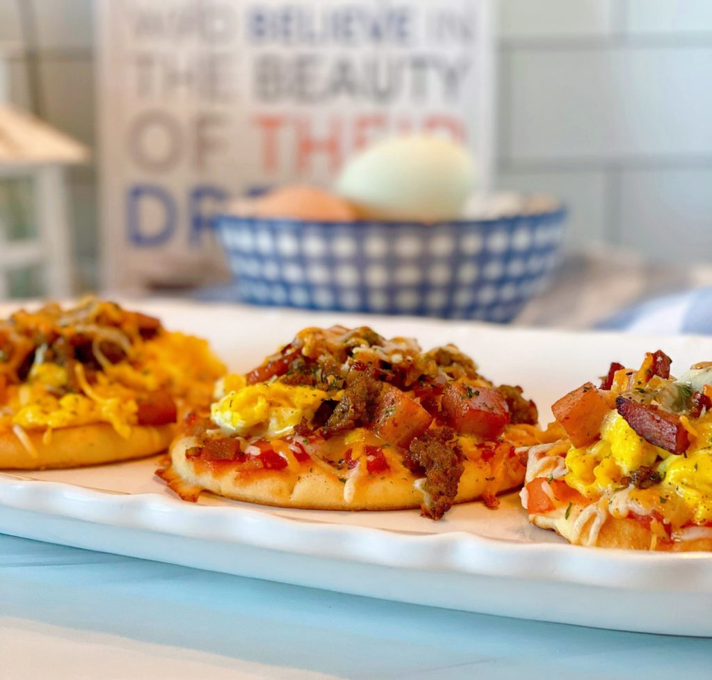 Breakfast pizzas on a platter.