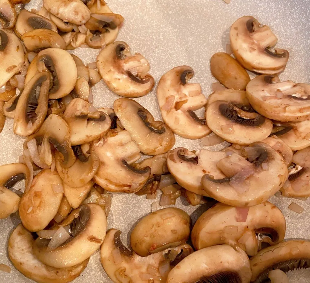 Mushrooms cooked in pan.