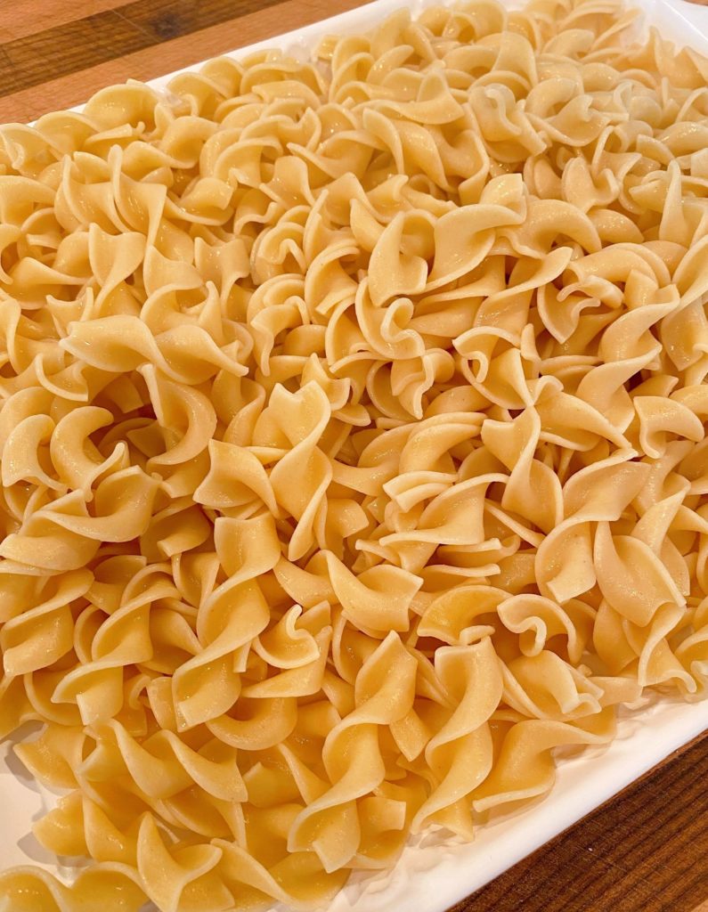 Egg noodles arranged on a large serving platter.