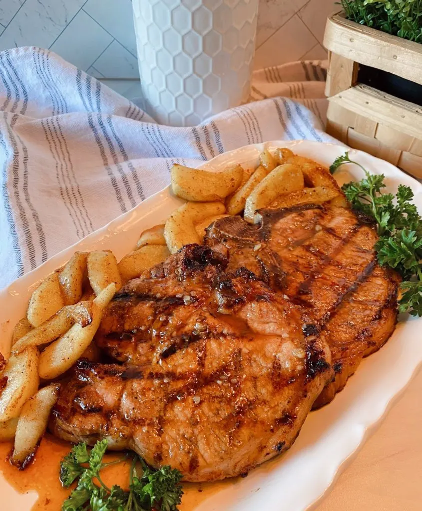 Grilled Pork Chops with Apple Slices and Honey Garlic Sauce.