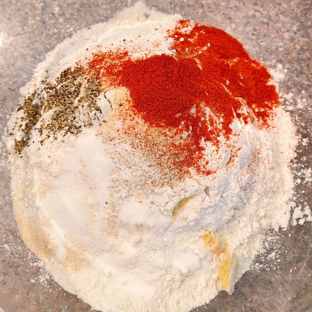 Dry ingredients in a large bowl for the fried chicken dredge.