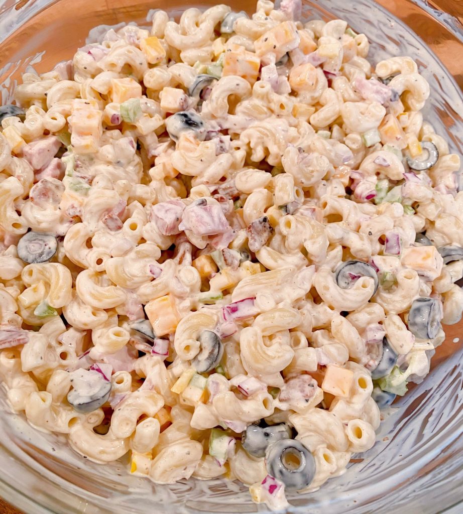 Macaroni Pasta salad mixed in a bowl ready to chill.