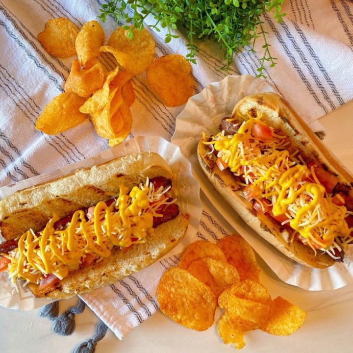 Polish Dogs with chips on a table.