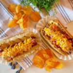 Polish Dogs with chips on a table.