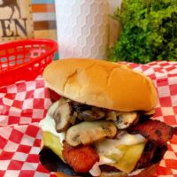 Blue Cheese Bacon Mushroom Burger on a red checkered paper