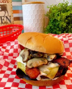 Blue Cheese Bacon Mushroom Burger on a red checkered paper
