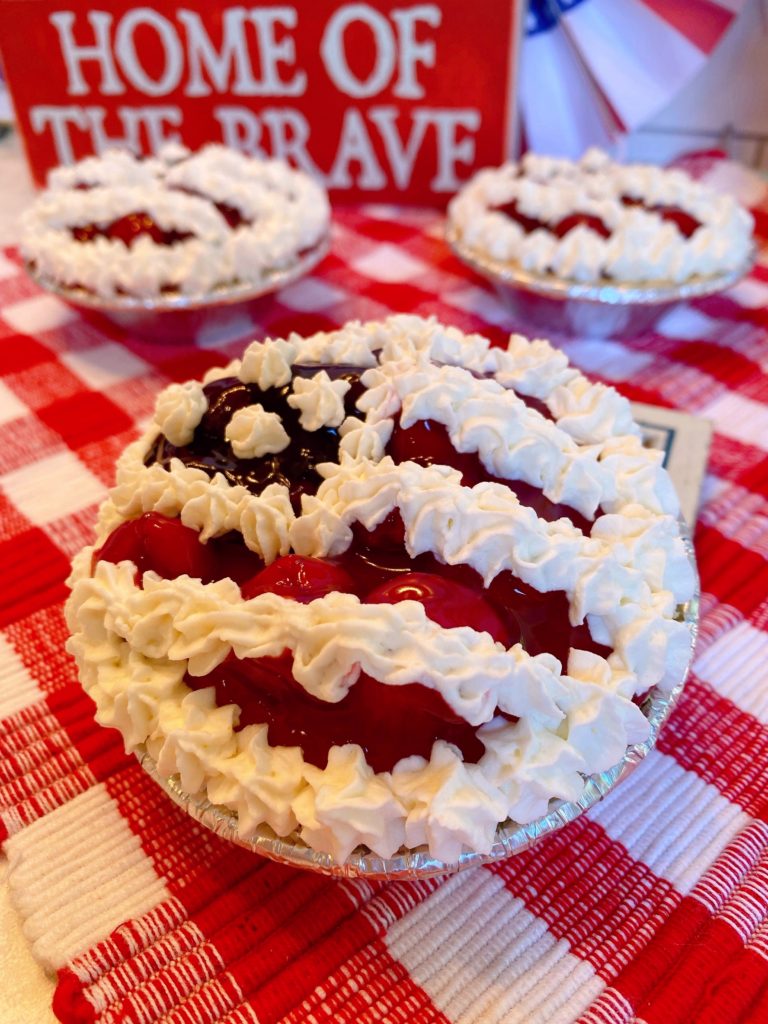 Mini No Bake Cheesecake Pies on a red checked clothed.