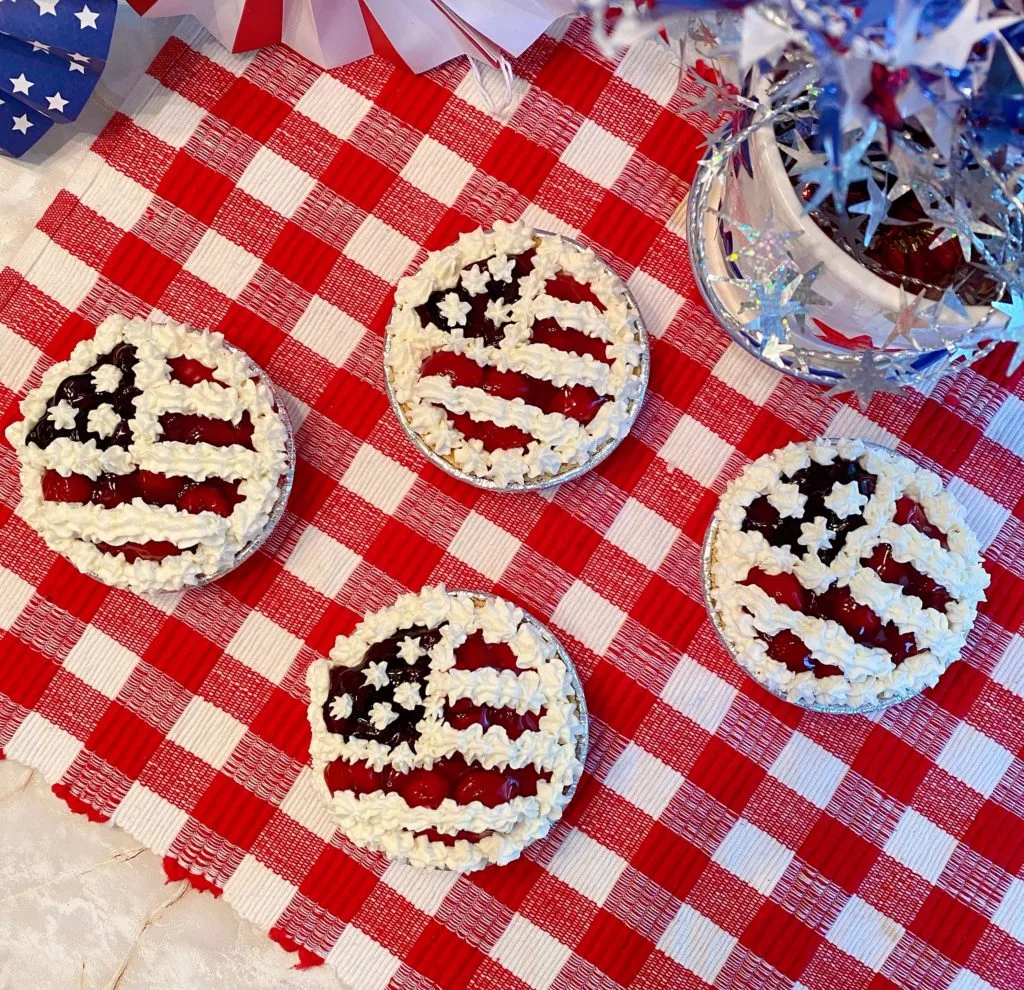 Overhead shot of 4 mini no-bake cheesecake pies.