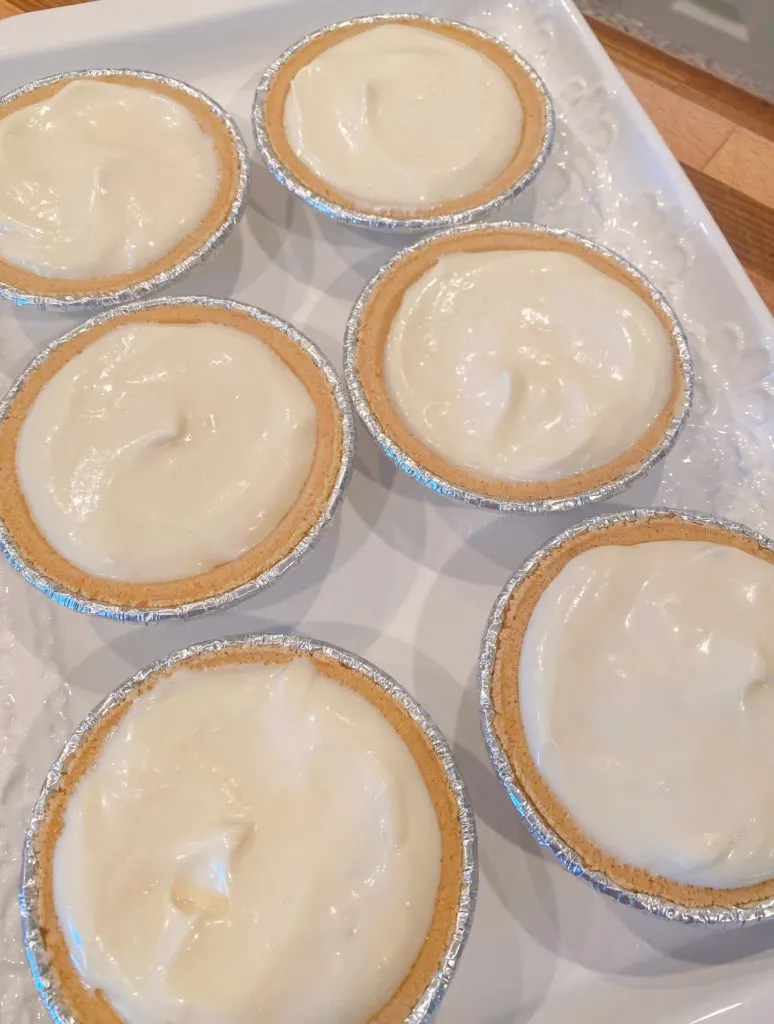 Mini no bake graham cracker pie crust filled with cream cheese filling.