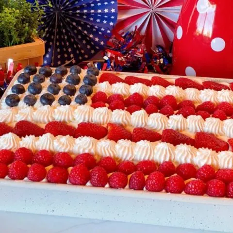 Red, White and Blue Poke Cake with fresh berries decorated like an American Flag.