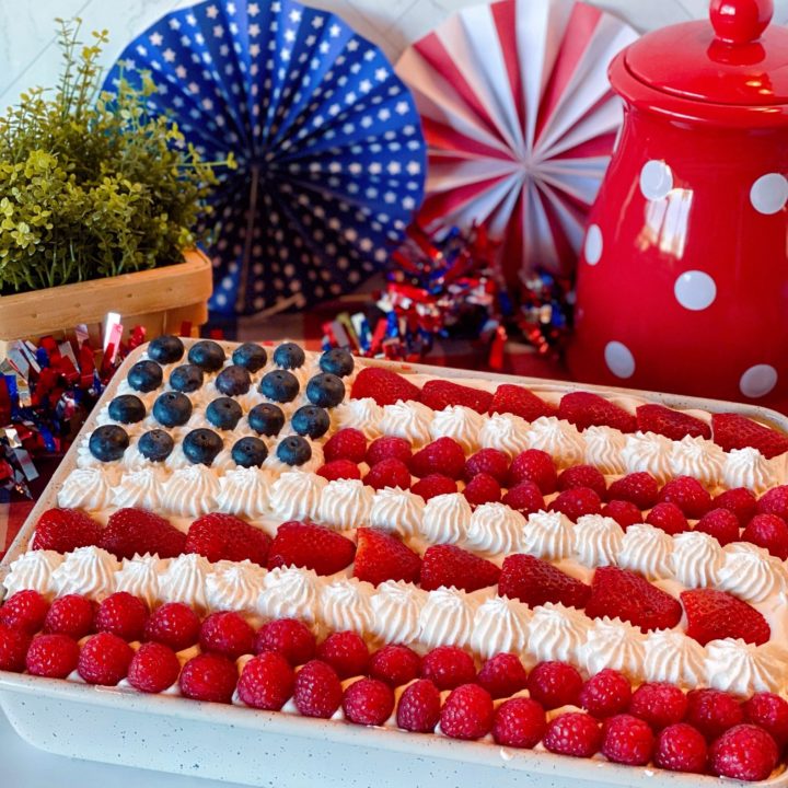 Red, White & Blue Poke Cake with Patriotic Background in a cake pan.