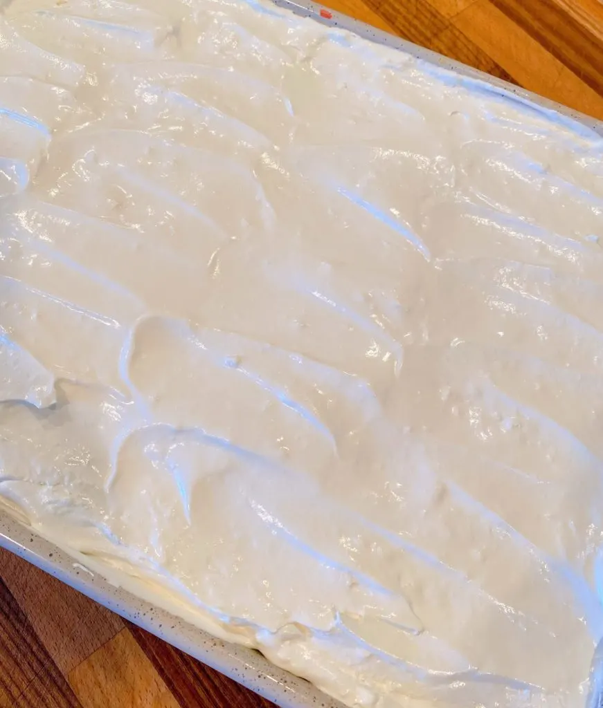 Cool Whip spread over the top of the cake ontop of the pudding.