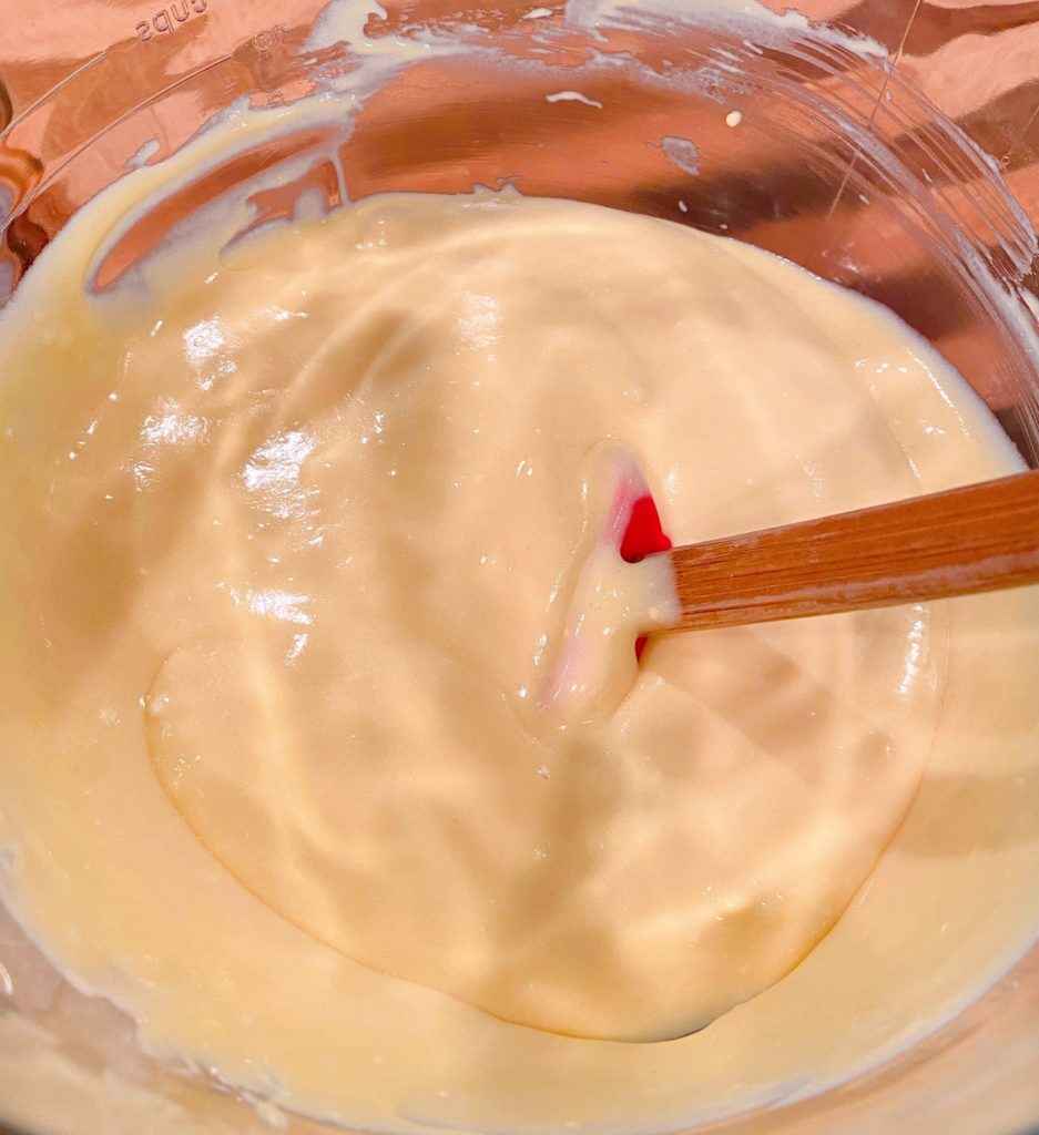 Yllow Cake Mix in mixing bowl with red spatula