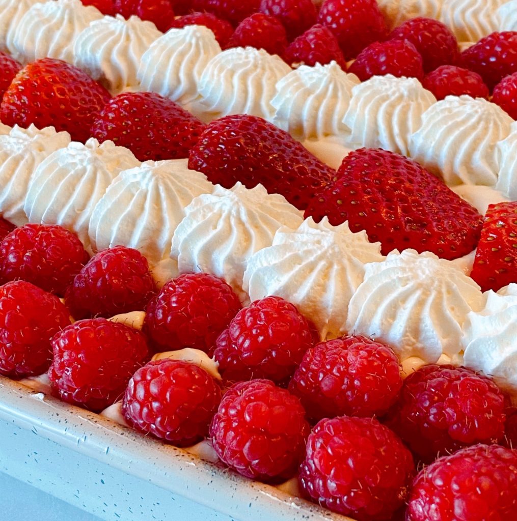 Close up of berries and whipped cream stripes