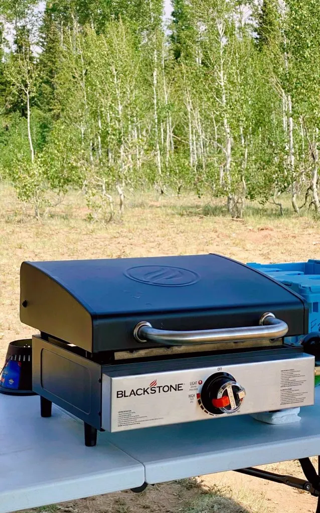Blackstone Griddle on a table in the woods.