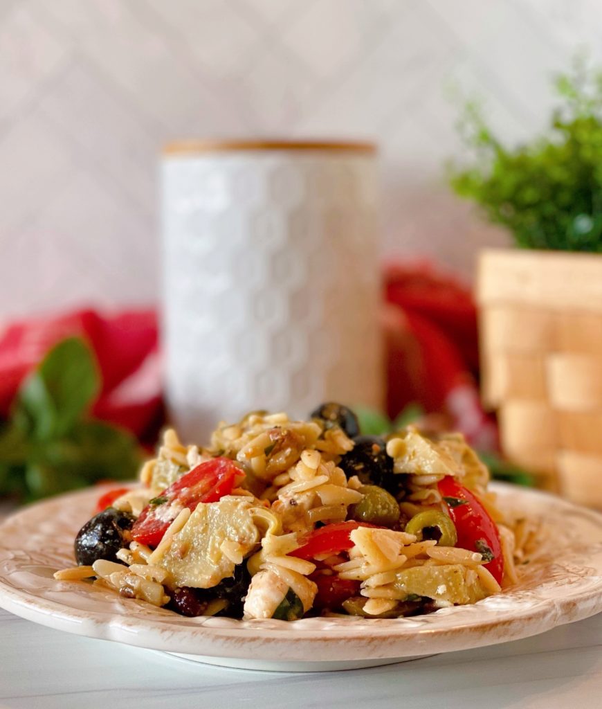 White plate with Muffuletta Olive Pasta Salad.