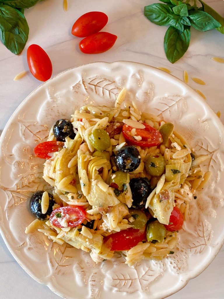 Muffuletta Olive Pasta Salad on a white plate single serving.