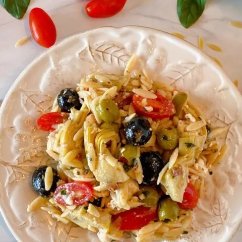 Muffuletta Olive Pasta Salad on a white plate single serving.