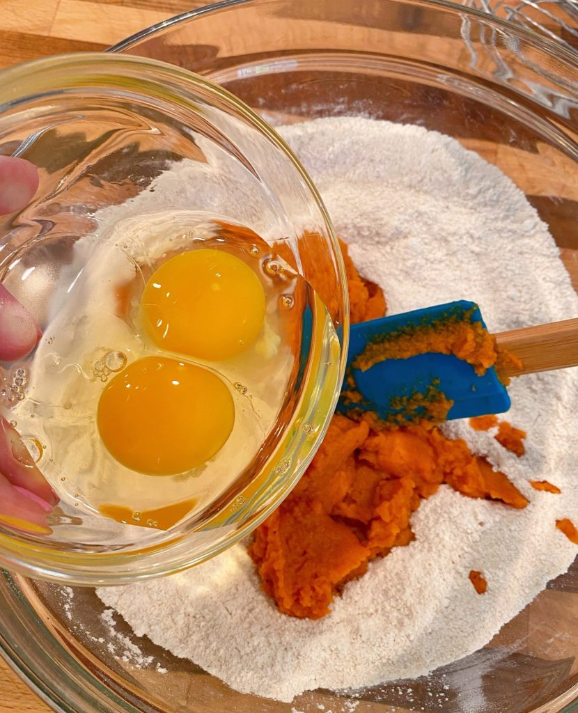 Adding pumpkin and eggs to dry ingredients.