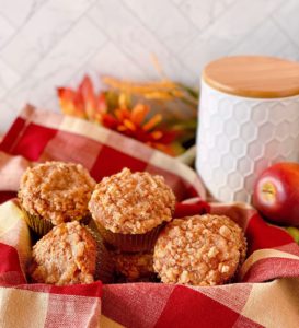 Pumpkin Apple Muffins in a basket on the kitchen counter.