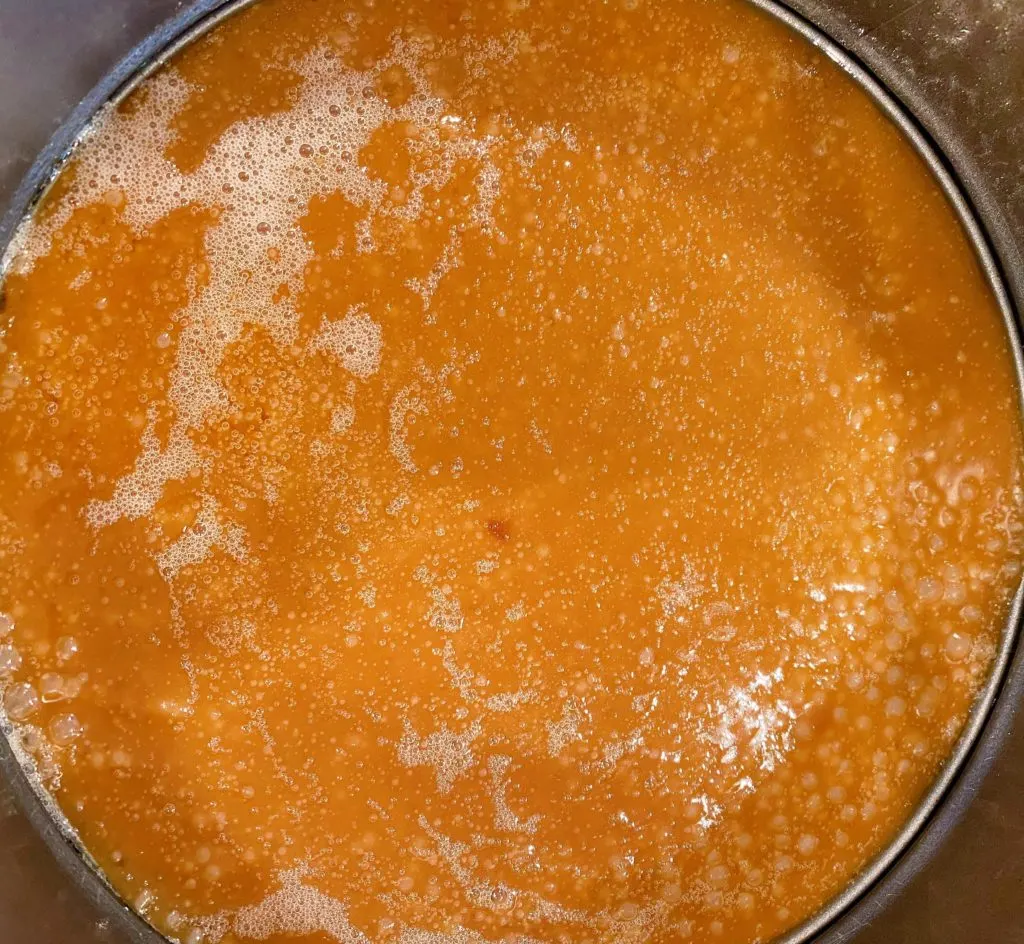 Brown sugar and butter boiling in a pan.