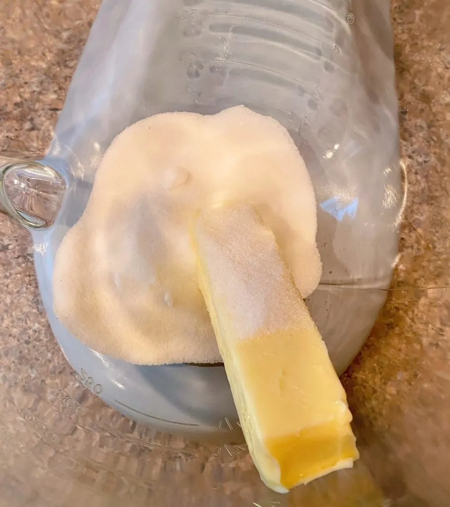 Butter and sugar in mixing bowl.