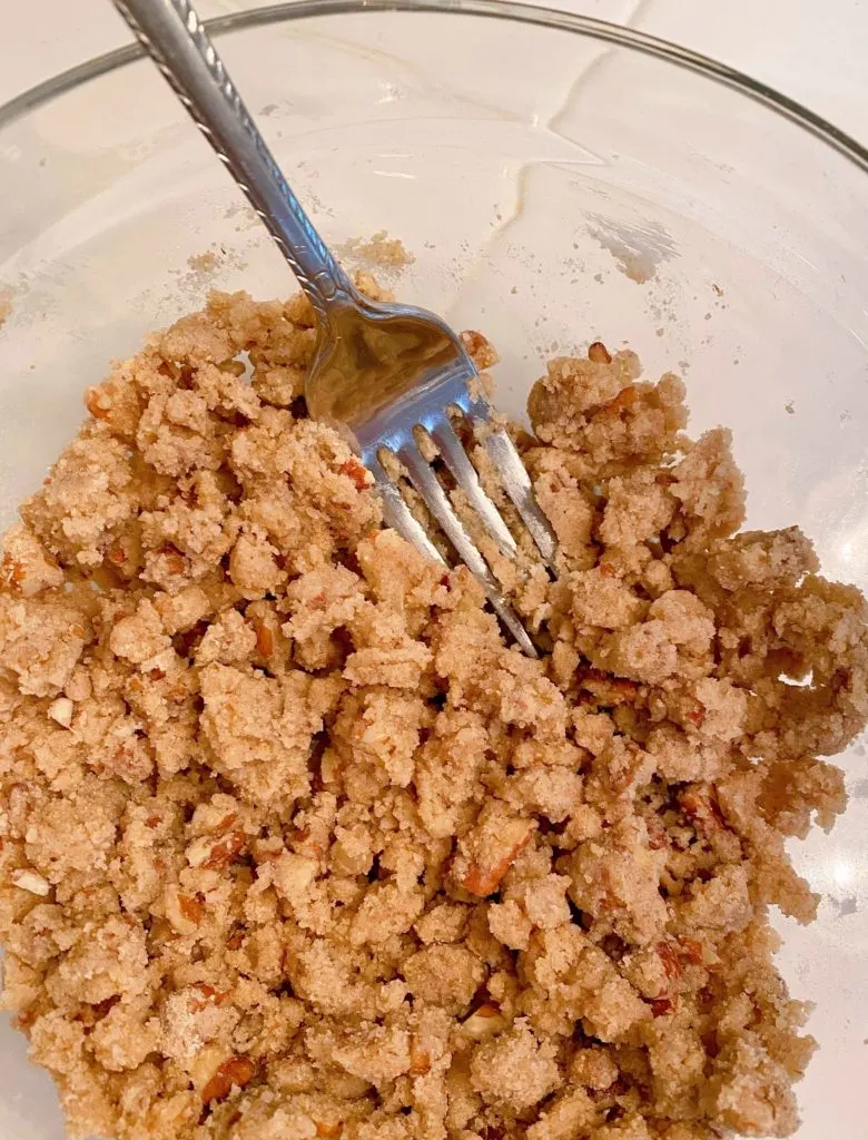 Using a fork to blend Streusel ingredients.