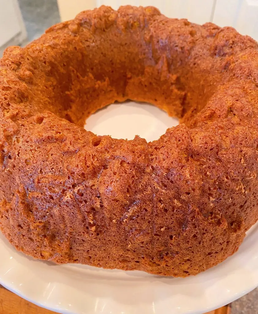 Cake cooling on plate waiting for glaze.