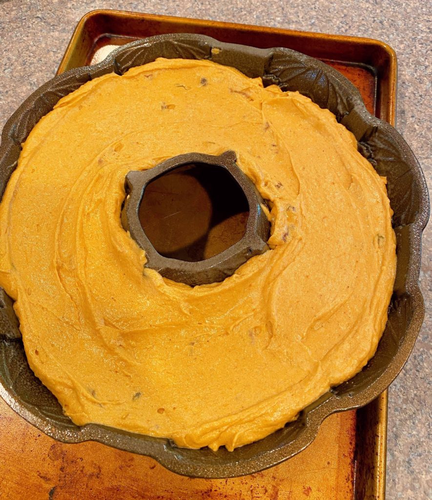 Batter spread in cake bundt pan ready for baking.