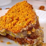 Slice of cake on a white plate ready to eat.