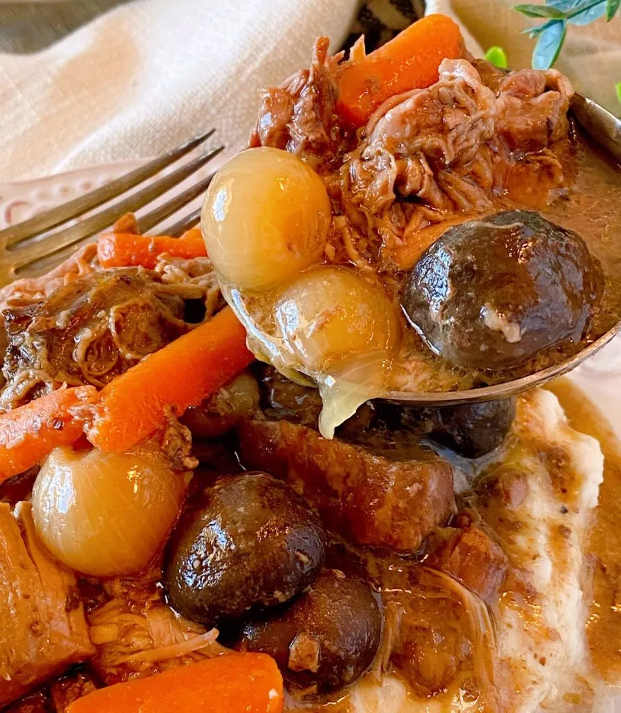 Slow Cooker Beef Burgundy close up with a ladle full of the mixture.