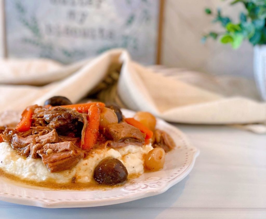 Serving of Slow Cooker Beef Burgundy over mashed potatoes.