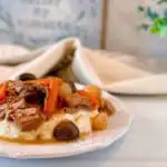 Serving of Slow Cooker Beef Burgundy over mashed potatoes.