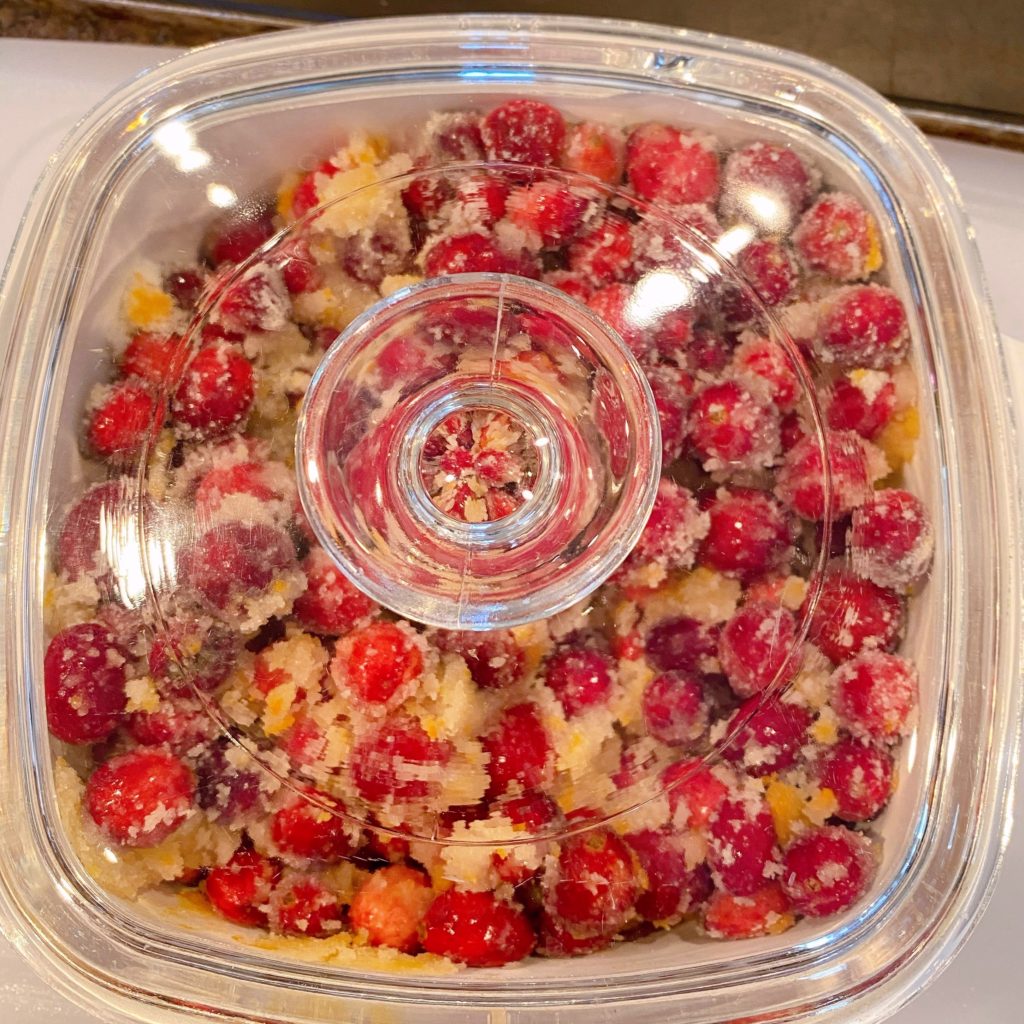 Brandied Cranberries ready to bake in a baking dish covered with lid.