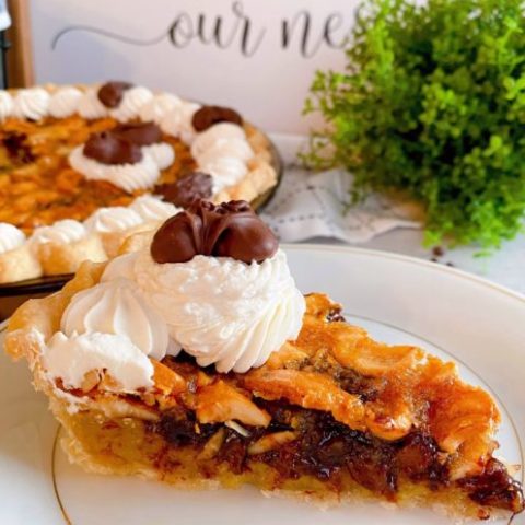 Slice of Pie on dessert plate with whole pie in the background.