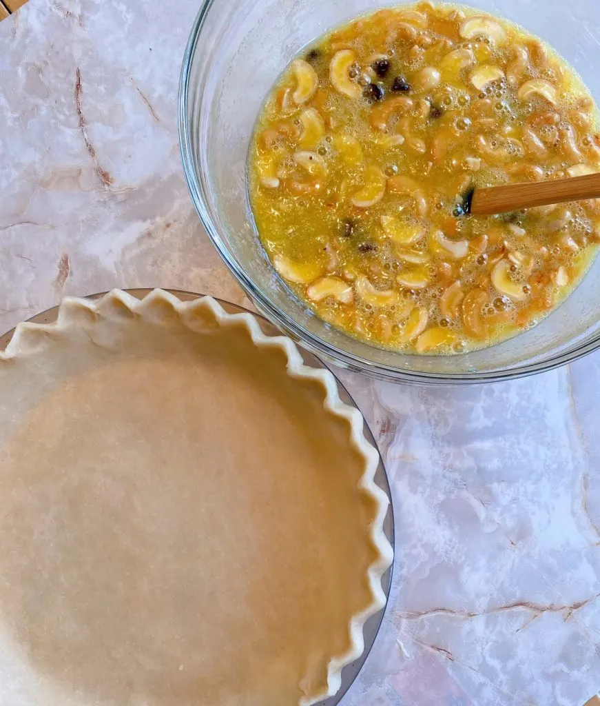 Pie Filling in a bowl with prepared pie crust next to it.