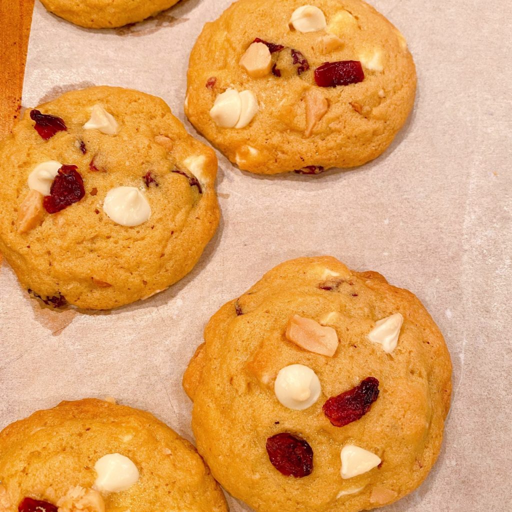 Cranberry and White Chocolate Chip cookies on baking sheet after baking.