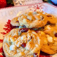 Christmas plate loaded with Cranberry White Chocolate Chip Cookies.